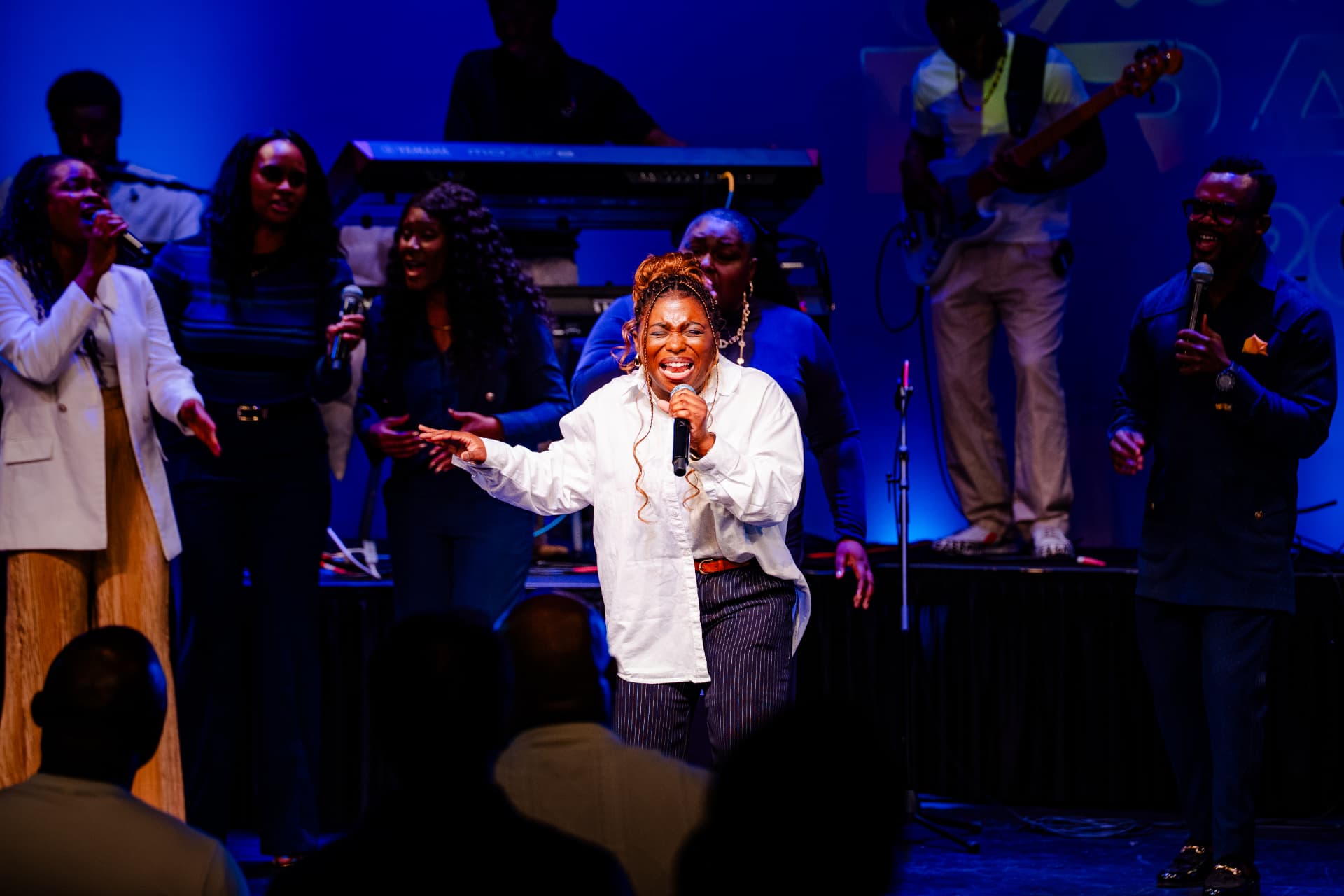 Lead vocalist singing with the worship team at Glorious Praise